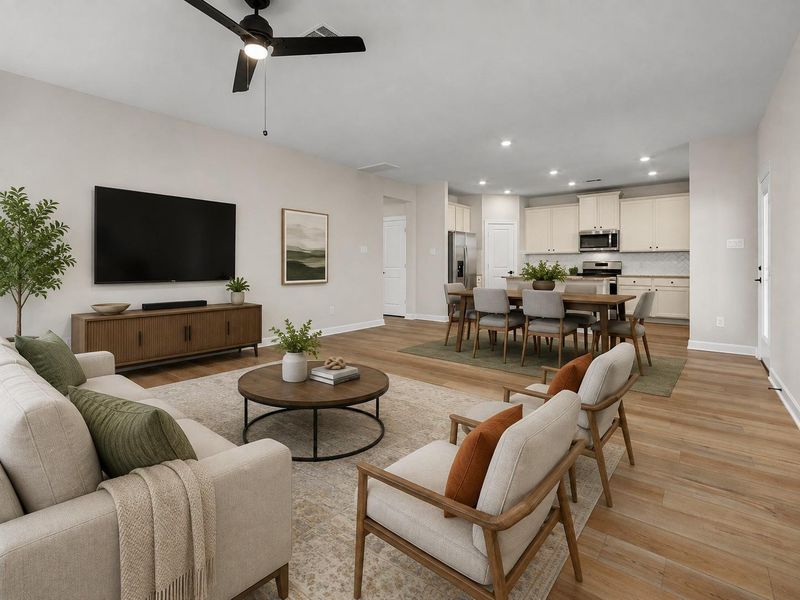 Open-concept living area with wood-look flooring, recessed lighting, and seamless flow to the kitchen.**Virtually staged Open-concept living area with wood-look flooring, recessed lighting, and seamless flow to the kitchen.**Virtually staged