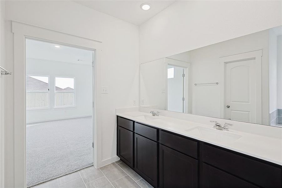 Bathroom featuring tile patterned flooring and vanity