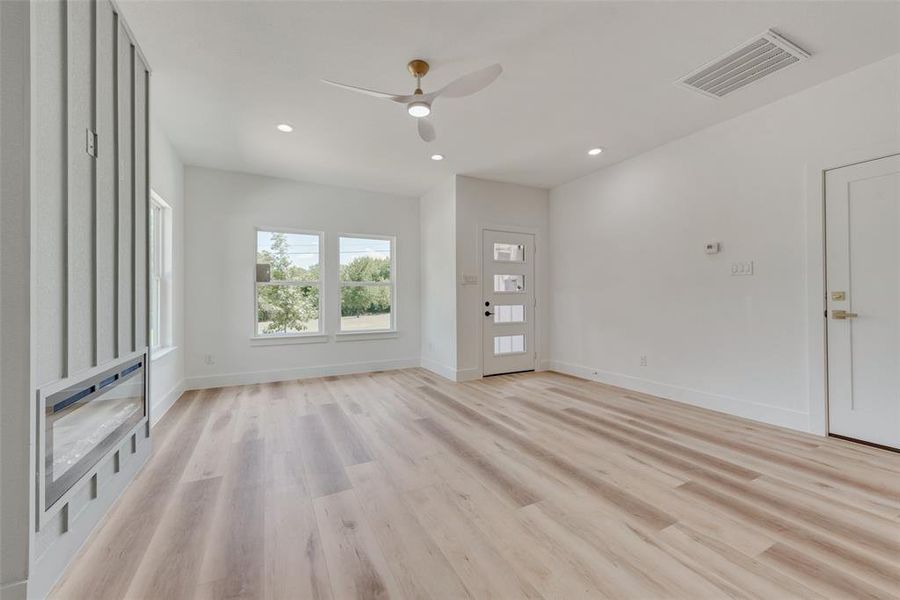 Empty room with light wood-type flooring and ceiling fan