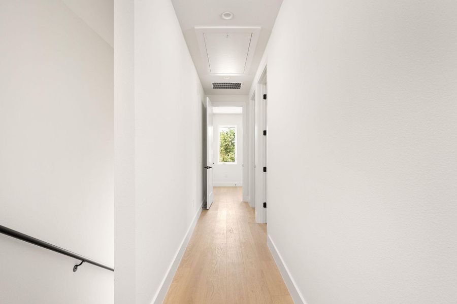 Crisp white walls and light wood flooring define this clean, minimalist hallway. Crisp white walls and light wood flooring define this clean, minimalist hallway.