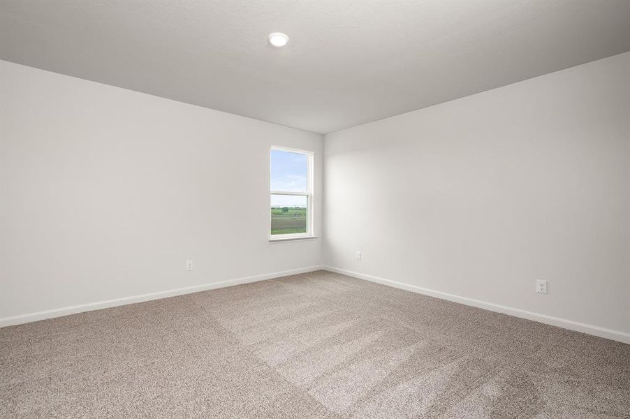 Carpeted empty room with baseboards