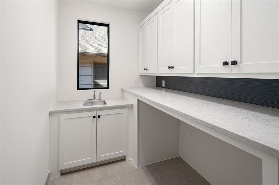 Laundry room featuring light tile patterned flooring and sink