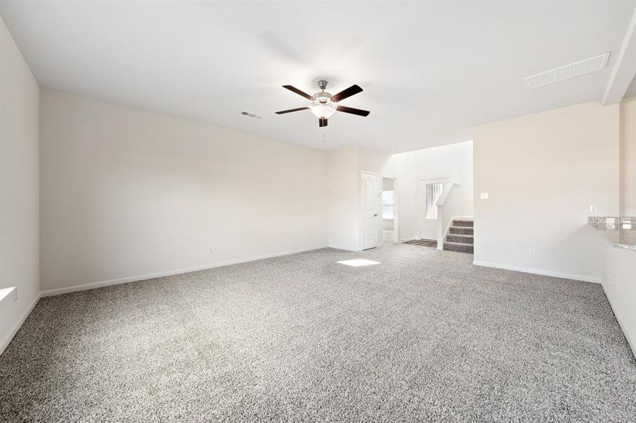 Unfurnished bedroom with light carpet and ceiling fan