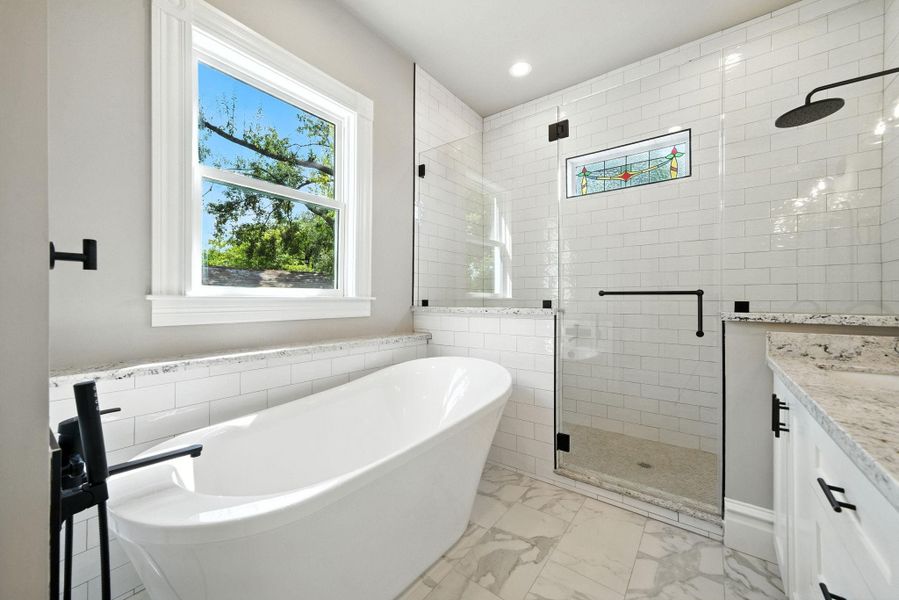 Note the window above the tub for natural light and stained glass window in the shower! Note the window above the tub for natural light and stained glass window in the shower!