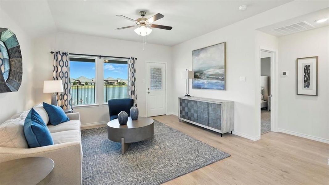 Living area featuring light wood-style floors and ceiling fan