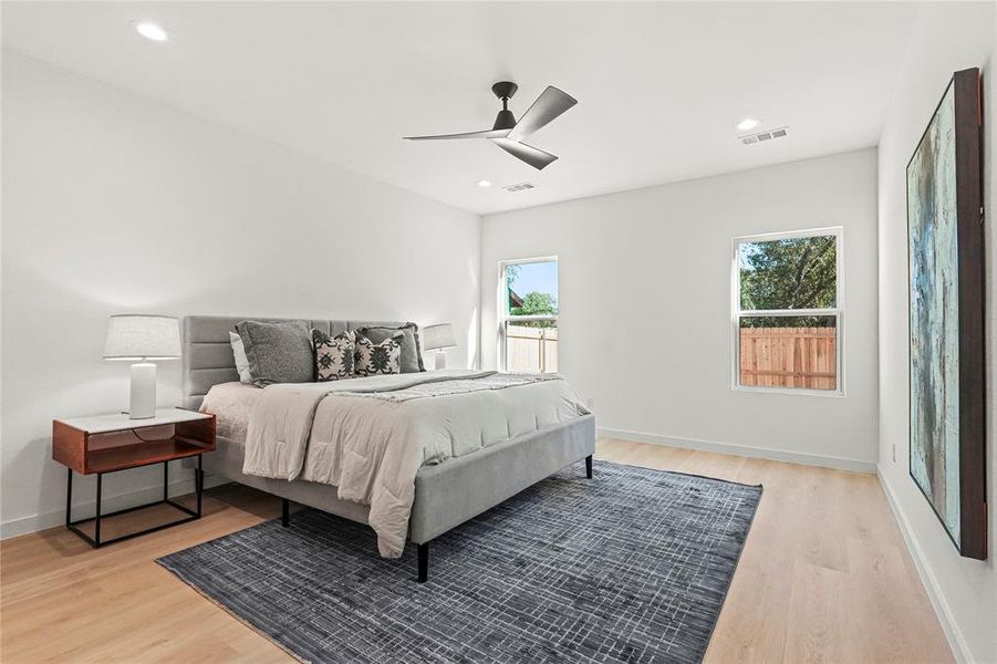 Bedroom featuring light wood-style floors, ceiling fan, and recessed lighting