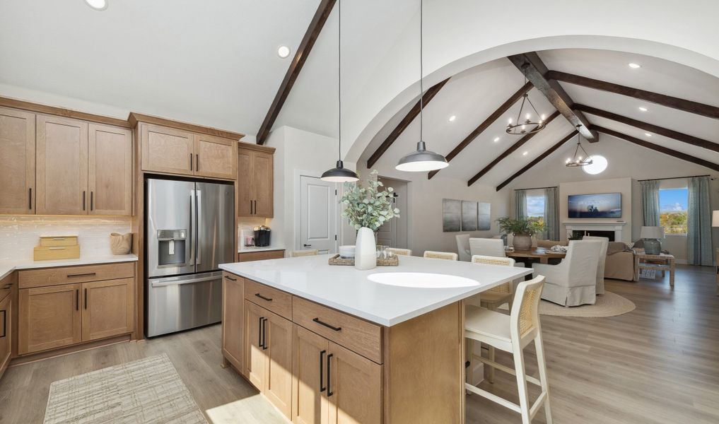 Kitchen overlooking great room with stained ceiling beams