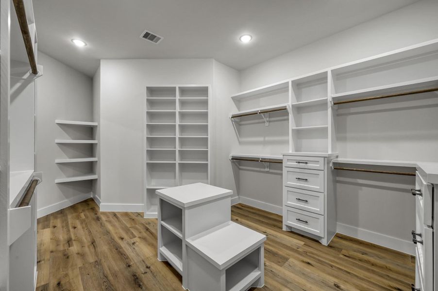 The massive walk-in closet has custom built-ins and provides abundant storage options. The massive walk-in closet has custom built-ins and provides abundant storage options.