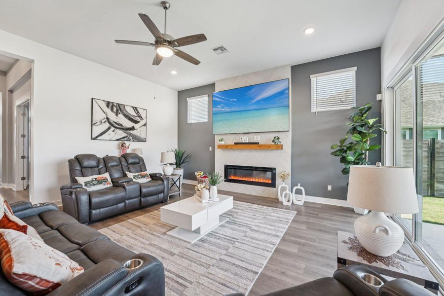 A sleek electric fireplace adds modern ambiance and serves as a striking focal point for the open layout.