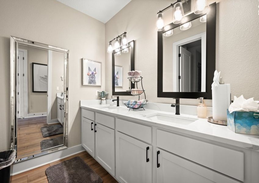 Secondary bathroom with double-sink vanity.