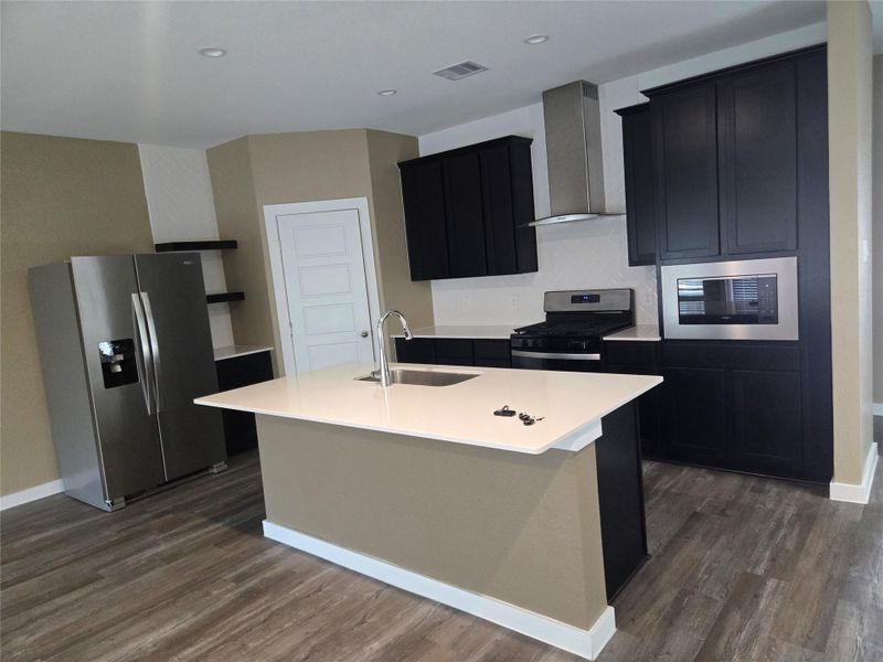 Dark cabinetry with stainless steel appliances And butler pantry. Dark cabinetry with stainless steel appliances And butler pantry.