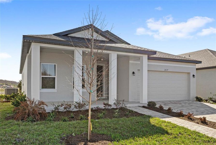 Front exterior of a new home in , Kissimmee, FL, highlighting curb appeal (Image 17).