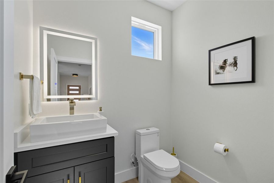 Bathroom with vanity and light wood finished floors