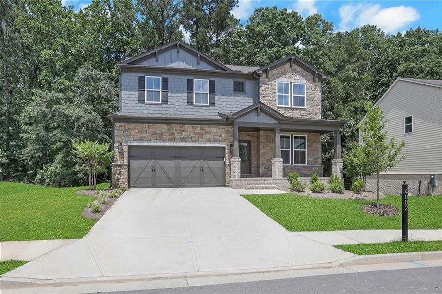 Front exterior of a new home in The Paddocks at Doc Hughes, Buford, GA, highlighting curb appeal (Image 29). Front exterior of a new home in The Paddocks at Doc Hughes, Buford, GA, highlighting curb appeal (Image 29).