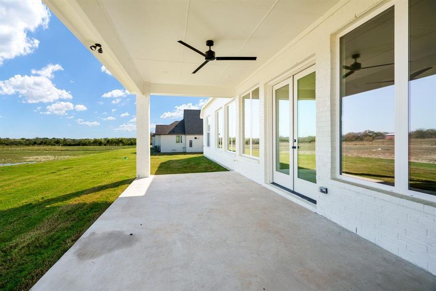 View of patio with a rural view and ceiling fan