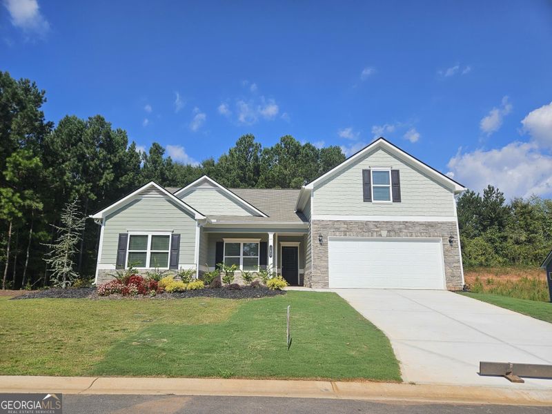Front exterior of a new home in Maddox Station, Eatonton, GA, highlighting curb appeal (Image 2). Front exterior of a new home in Maddox Station, Eatonton, GA, highlighting curb appeal (Image 2).