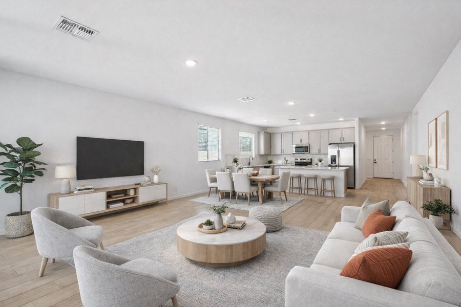 Great room, dining and kitchen. Virtually staged. Finishes may vary by community.