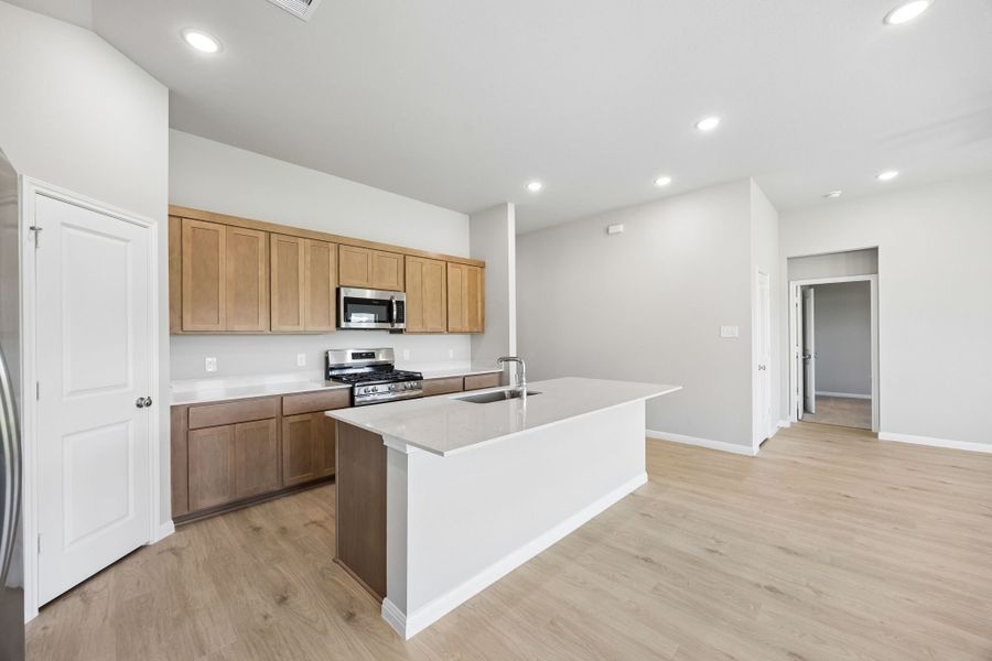 Kitchen in the Sabine home plan by Trophy Signature Homes – REPRESENTATIVE PHOTO Kitchen in the Sabine home plan by Trophy Signature Homes – REPRESENTATIVE PHOTO