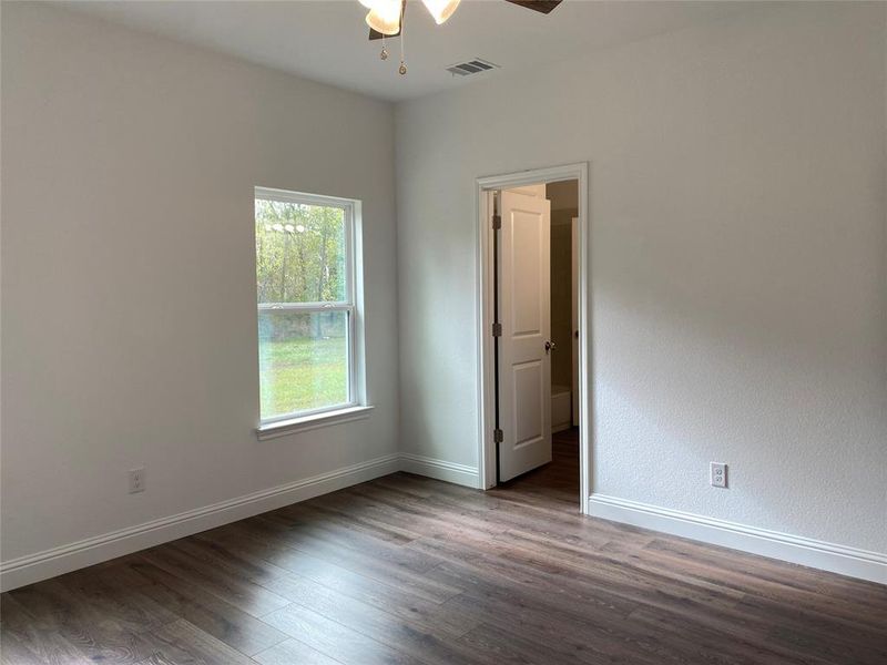 Bedroom featuring dark wood finished floors and ceiling fan Bedroom featuring dark wood finished floors and ceiling fan