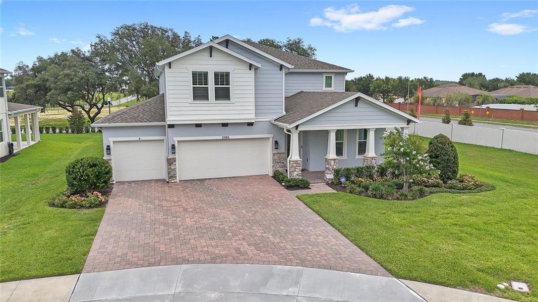 Front exterior of a new home in Acuera Estates, Apopka, FL, highlighting curb appeal (Image 2). Front exterior of a new home in Acuera Estates, Apopka, FL, highlighting curb appeal (Image 2).
