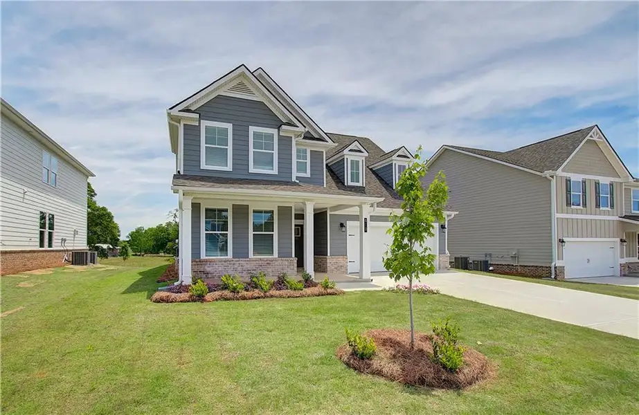 Front exterior of a new home in Cooper Park, McDonough, GA, highlighting curb appeal (Image 15).