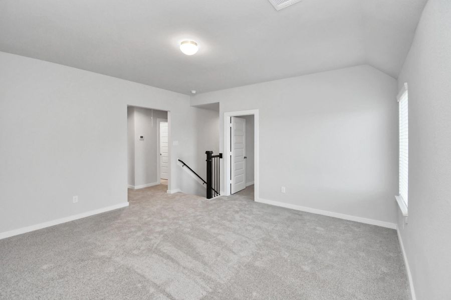Ascend to relaxation in this fantastic game room! Ideal for both casual gatherings and adult gaming, it boasts plush carpet, lofty ceilings, custom paint, and ample windows for abundant natural light.