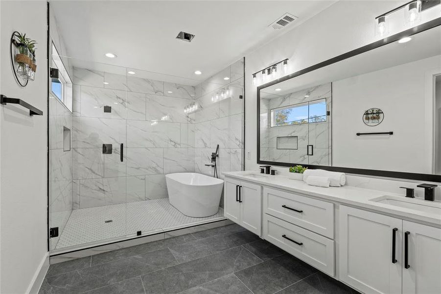 Bathroom featuring plus walk in shower and vanity