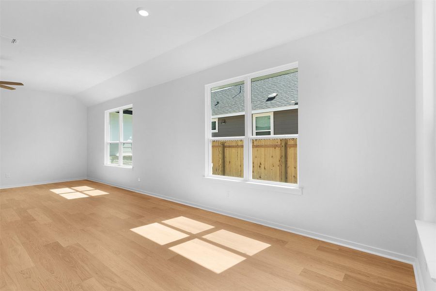 Spare room with light wood-style flooring, lofted ceiling, and recessed lighting Spare room with light wood-style flooring, lofted ceiling, and recessed lighting