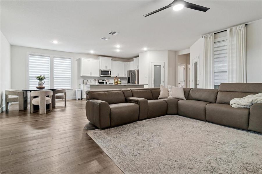 Living room with dark wood finished floors and recessed lighting Living room with dark wood finished floors and recessed lighting