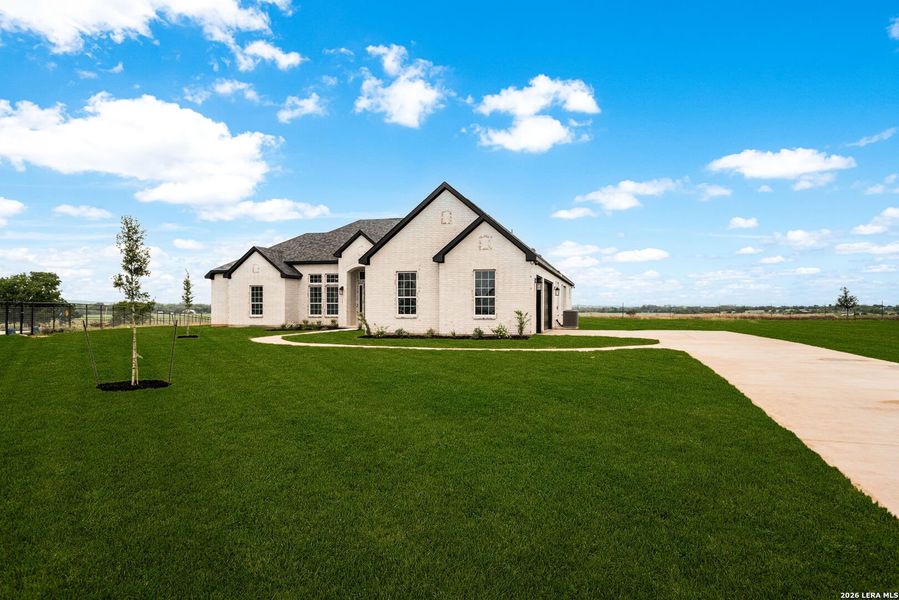 Front exterior of a new home in , Castroville, TX, highlighting curb appeal (Image 30).