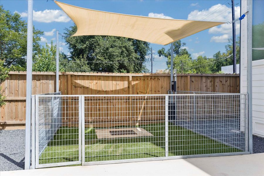One of two dedicated fenced dog runs with turf, shade sail, and waste station makes caring for four legged family members simple and convenient.