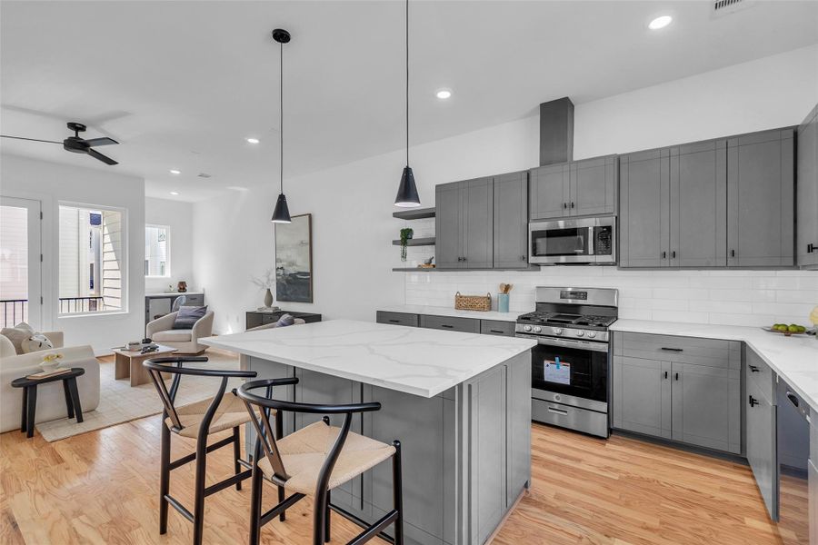 Experience the bright, airy elegance of this kitchen with its stunning quartz countertops. Experience the bright, airy elegance of this kitchen with its stunning quartz countertops.