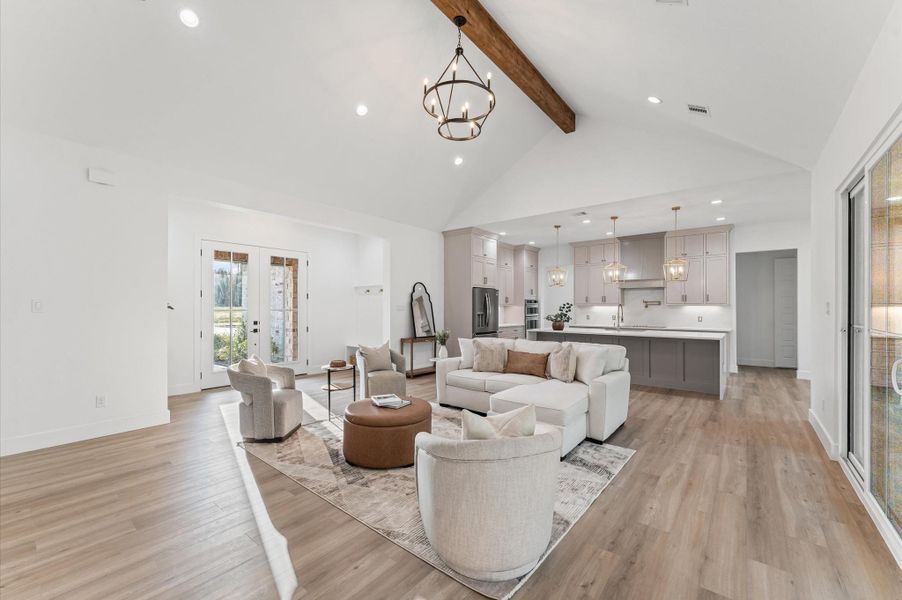 Open-concept living area with soaring cathedral ceilings, large windows for natural light, and LED recessed lighting throughout — a space where luxury meets comfort. Open-concept living area with soaring cathedral ceilings, large windows for natural light, and LED recessed lighting throughout — a space where luxury meets comfort.