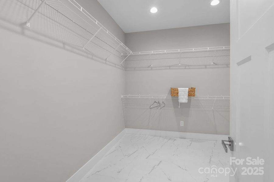 One of two spacious walk-in closets in the primary bedroom, offering generous storage and easy organization.