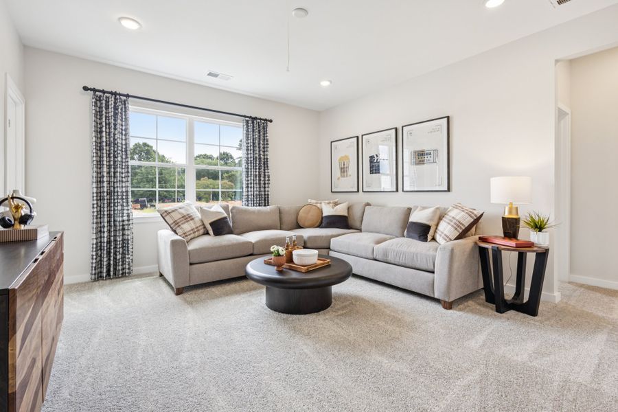 A living room with a couch and a coffee table. A living room with a couch and a coffee table.