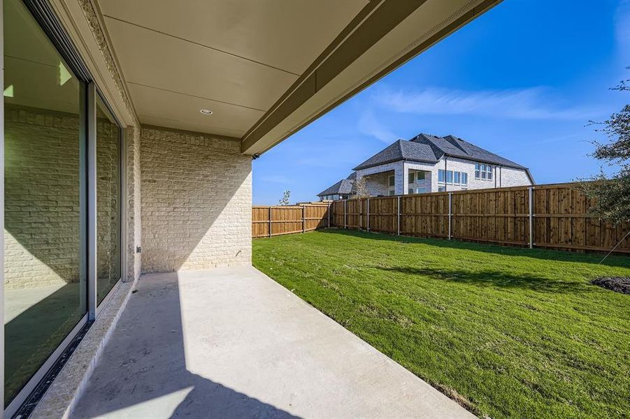 Fenced backyard with a patio