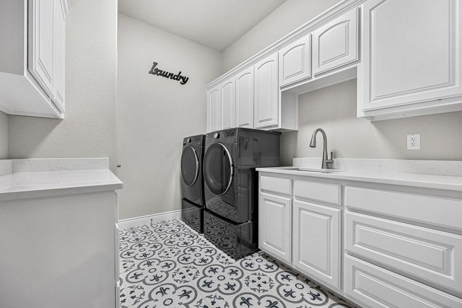 A well-appointed laundry room features custom cabinetry and a utility sink for practical daily living. A well-appointed laundry room features custom cabinetry and a utility sink for practical daily living.