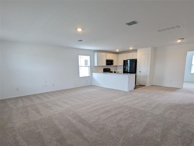An open floorplan seamlessly connects the living area with a well-appointed kitchen.