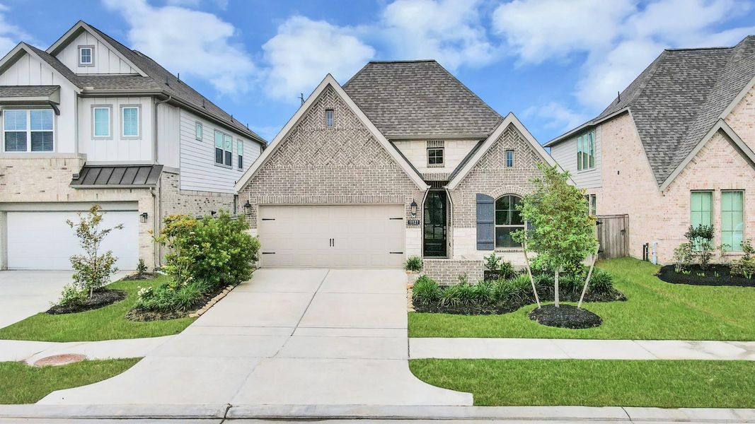 Front exterior of a new home in Bridgeland, Cypress, TX, highlighting curb appeal (Image 2). Front exterior of a new home in Bridgeland, Cypress, TX, highlighting curb appeal (Image 2).