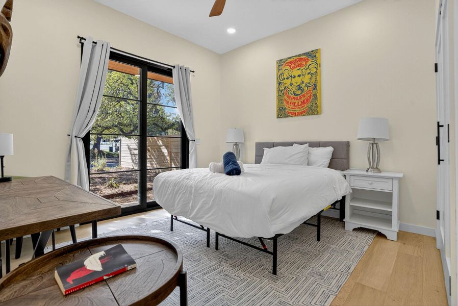 Bedroom featuring light wood finished floors, recessed lighting, ceiling fan, and access to exterior