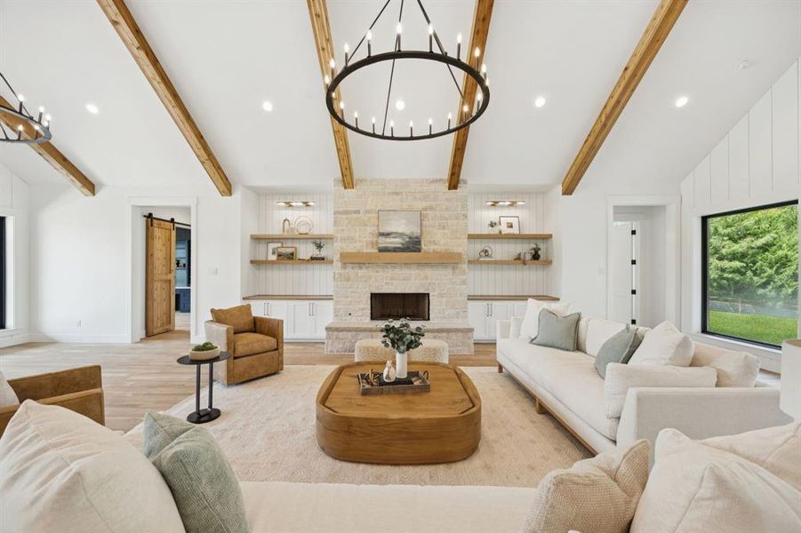Soaring ceilings, wood beams and a stone fireplace showcase the living room. Soaring ceilings, wood beams and a stone fireplace showcase the living room.