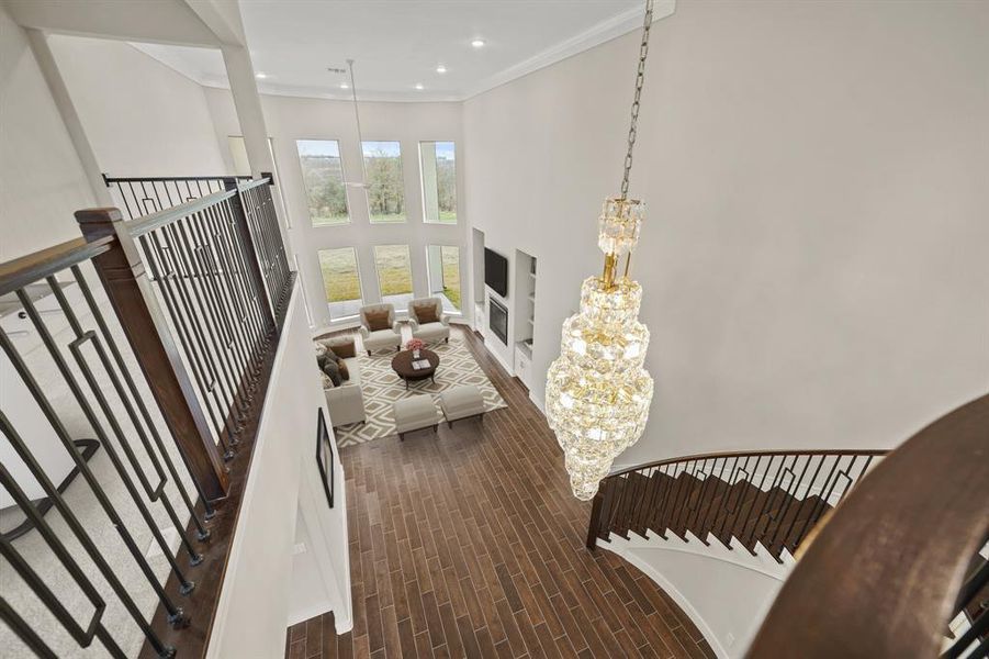 Virtually Staged: This view of the living room from the second floors is just breathtaking. Check out the one of a kind chandelier with incredible details.