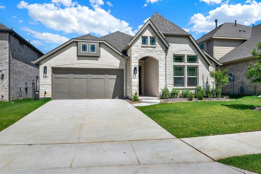 Front exterior of a new home in Union Park, Little Elm, TX, highlighting curb appeal (Image 22). Front exterior of a new home in Union Park, Little Elm, TX, highlighting curb appeal (Image 22).