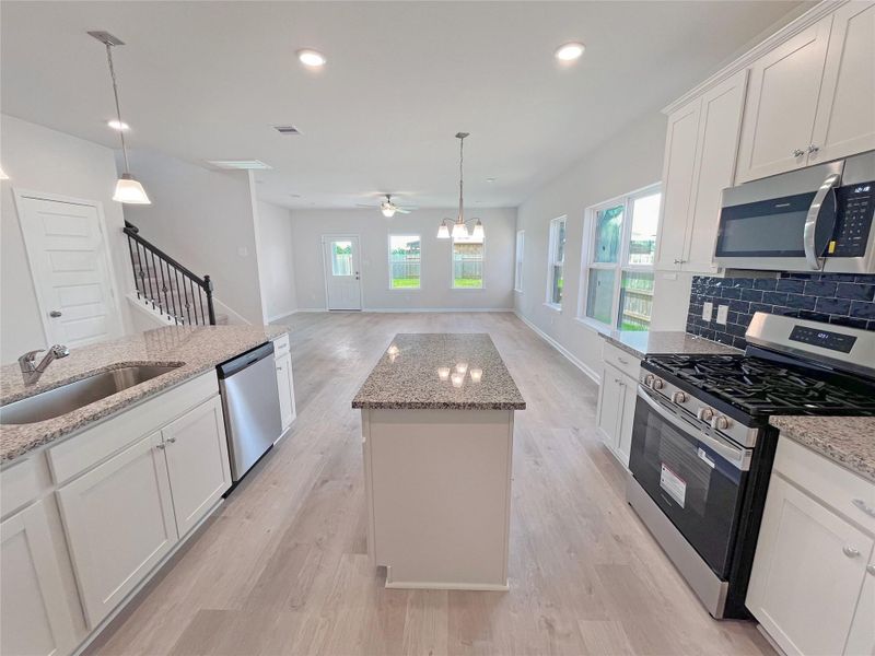 The Georgetown II- Kitchen into Family Room.Sample image for illustration; upgrades, options, and colors may vary.