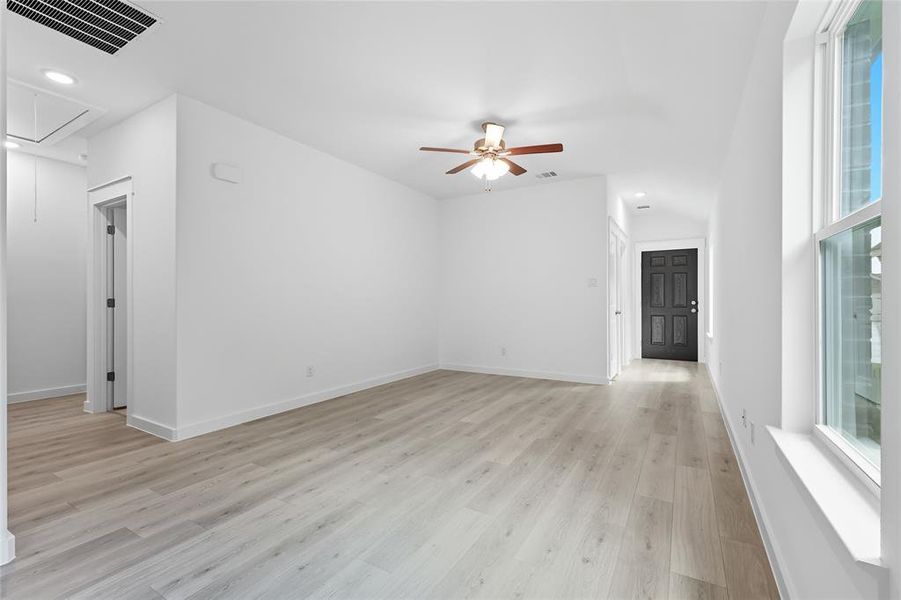 Unfurnished living room featuring attic access, light wood-type flooring, recessed lighting, and ceiling fan Unfurnished living room featuring attic access, light wood-type flooring, recessed lighting, and ceiling fan