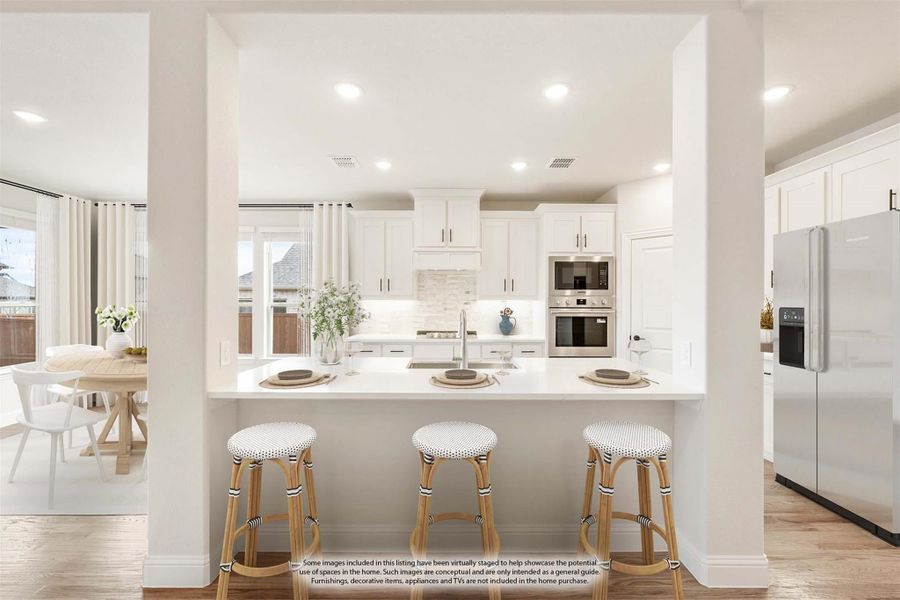 White kitchen with island, three bar stools, stainless steel appliances, and view of dining area