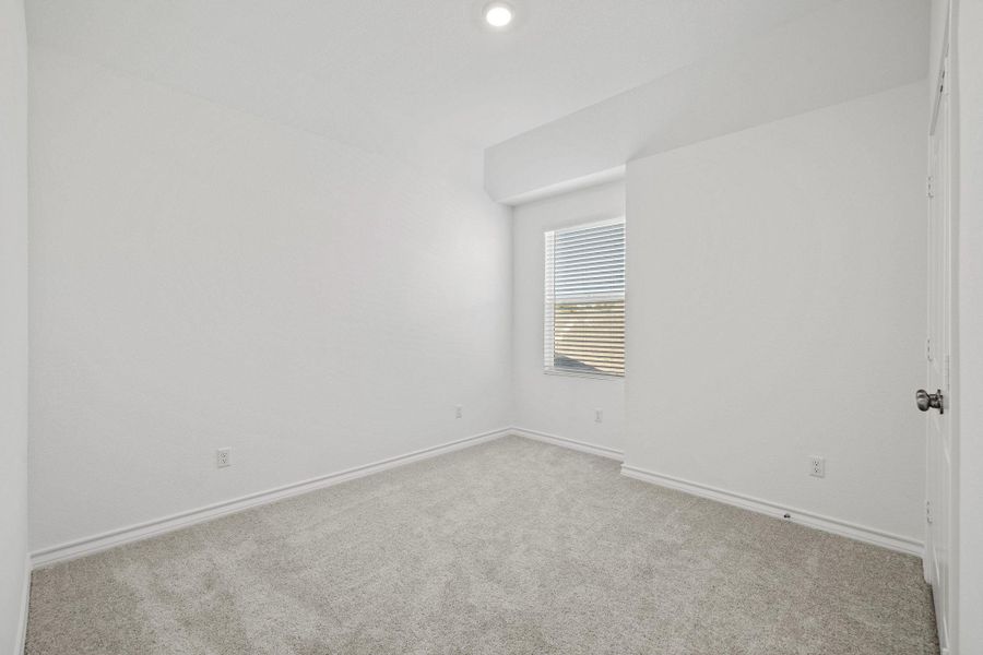 Carpeted empty room featuring baseboards