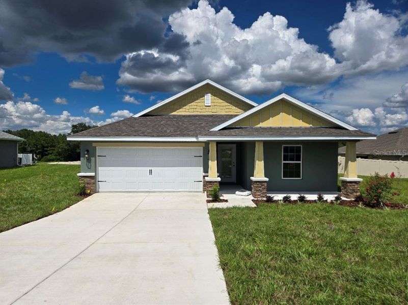 Front exterior of a new home in Twisted Oaks, Beverly Hills, FL, highlighting curb appeal (Image 1). Front exterior of a new home in Twisted Oaks, Beverly Hills, FL, highlighting curb appeal (Image 1).