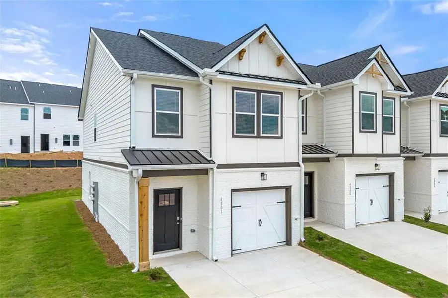 Front exterior of a new home in The Grove At Mundy Mill, Gainesville, GA, highlighting curb appeal (Image 2). Front exterior of a new home in The Grove At Mundy Mill, Gainesville, GA, highlighting curb appeal (Image 2).