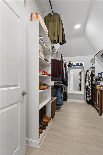 Walk in closet with vaulted ceiling